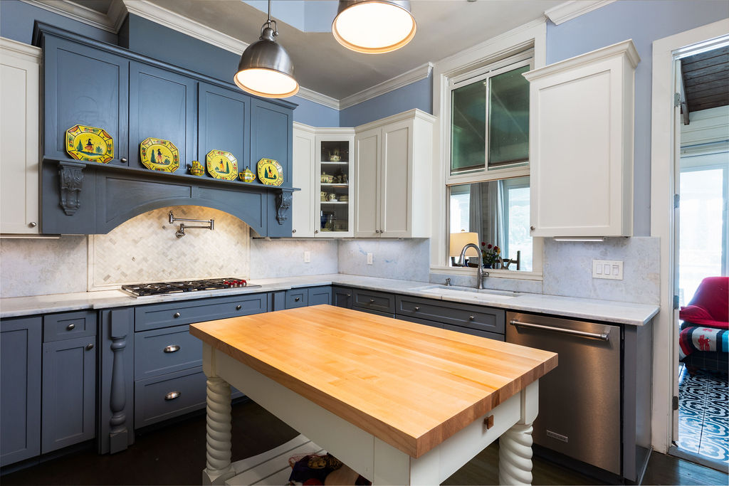 Chef's kitchen with butcher block island and marble counters