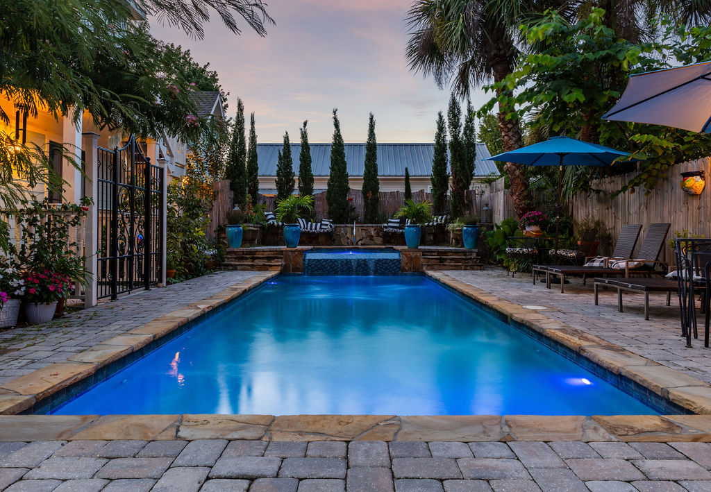 Backyard pool and courtyard at twilight