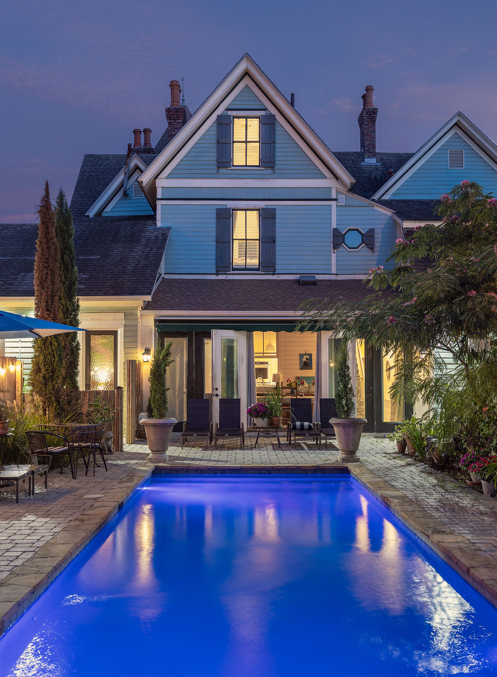 Pool and rear elevation glowing at blue hour